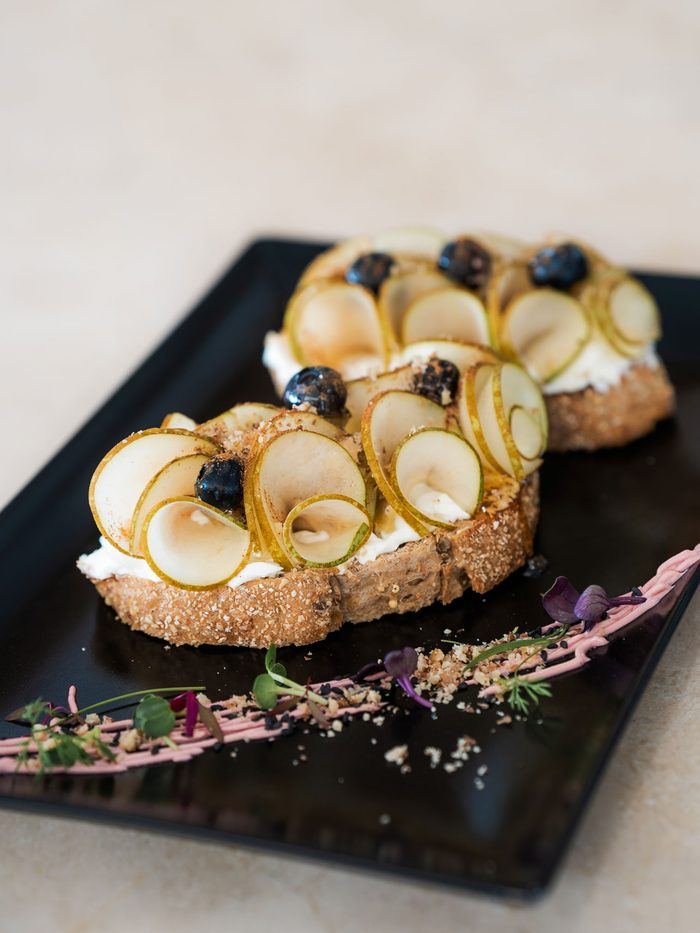 Pear and goat cheese toast with blueberries.